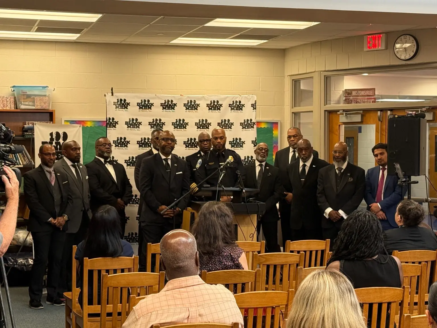 100 Black Men of Akron members and community leaders participating in a press conference