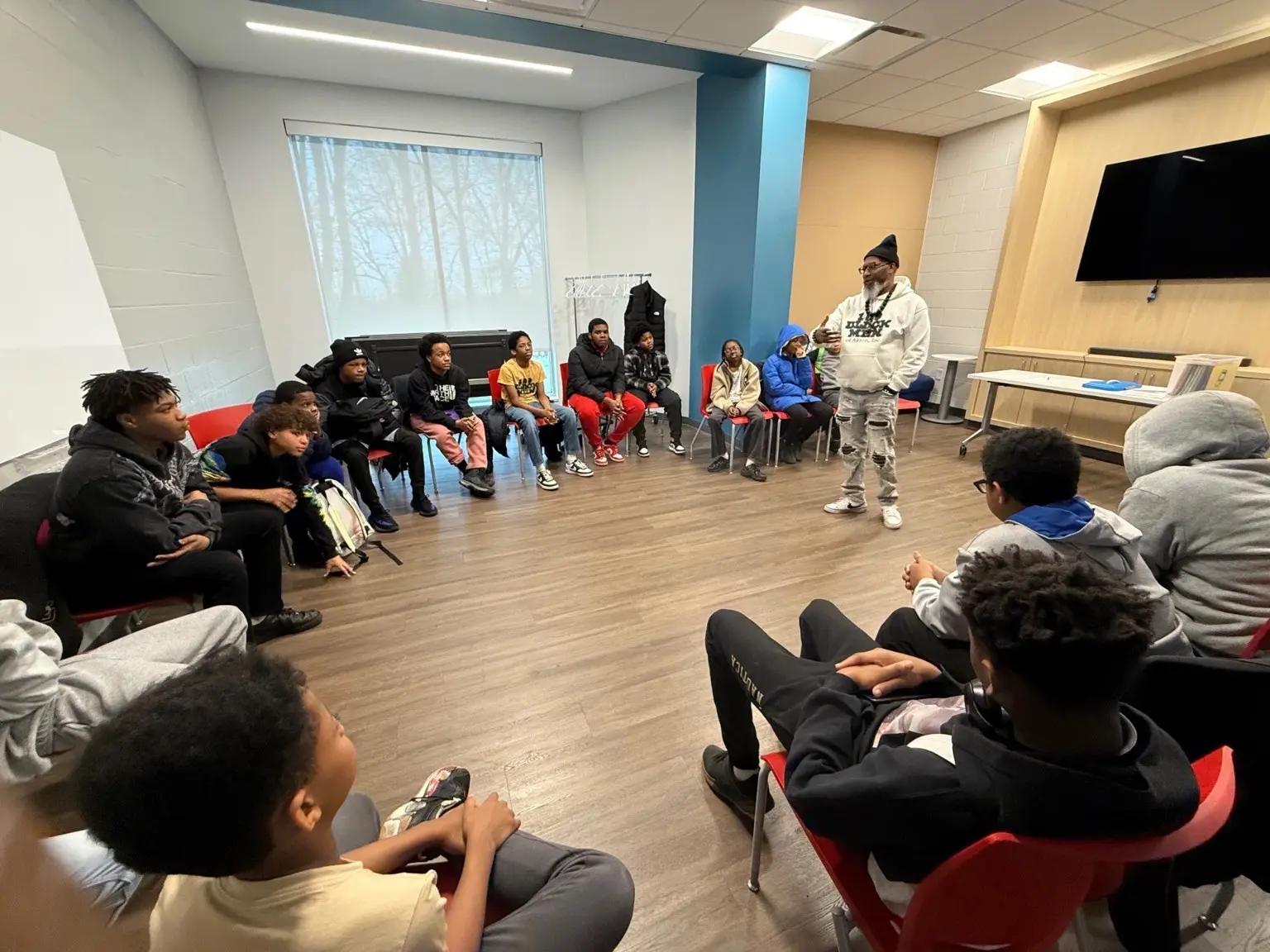 A 100 Black Men of Akron mentor leading a discussion with young people