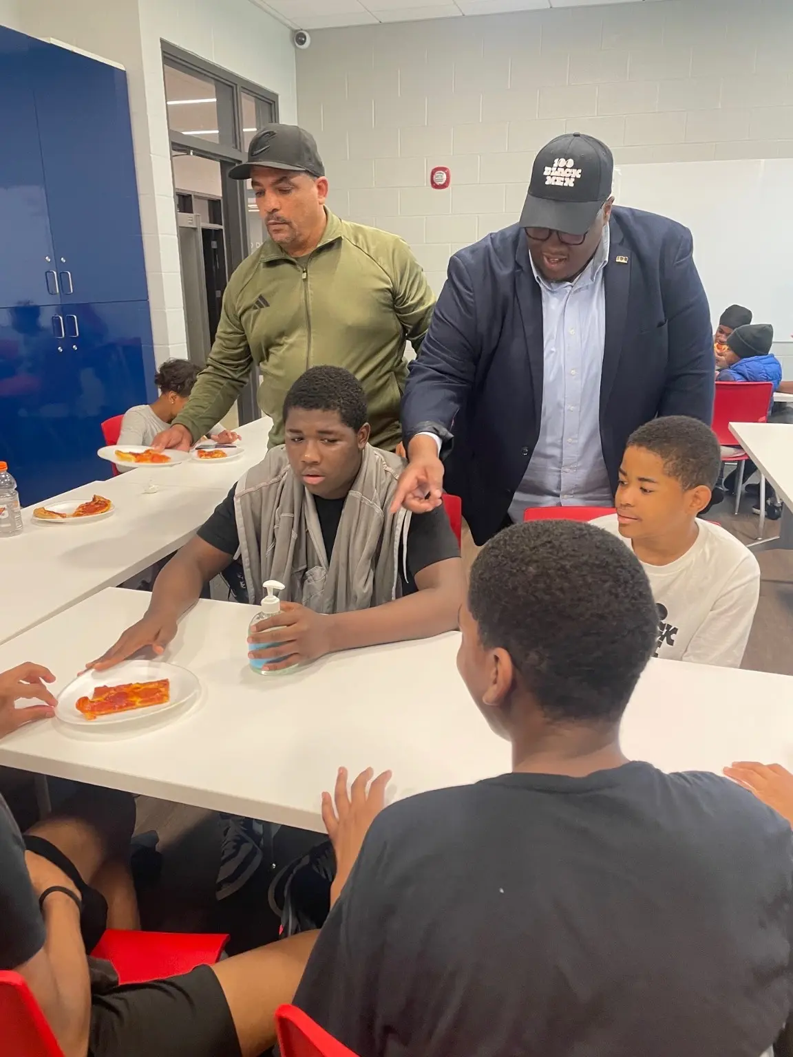 Mentors working alongside young people during a 100 Black Men of Akron program gathering